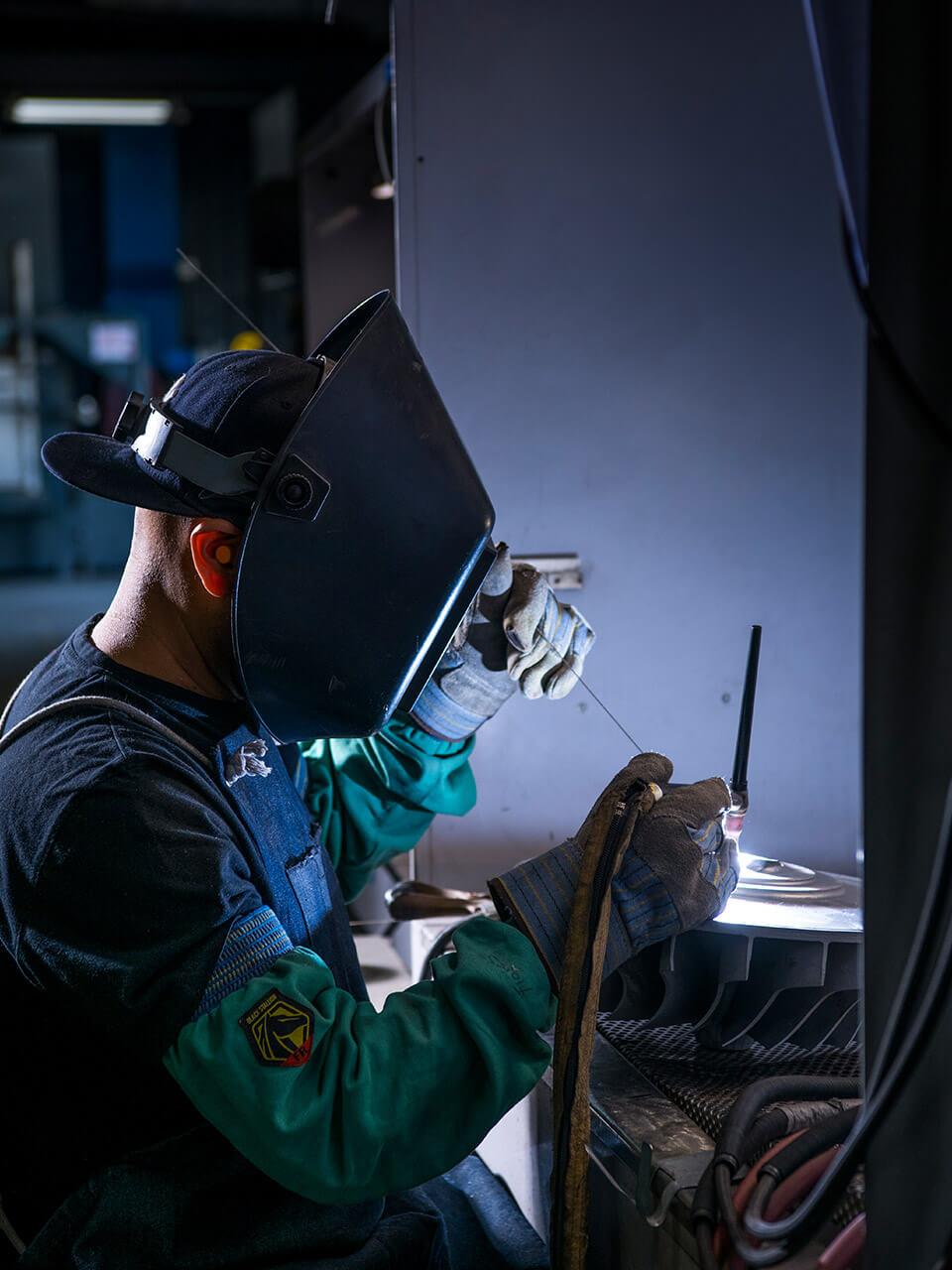 Image of a steel castings worker welding