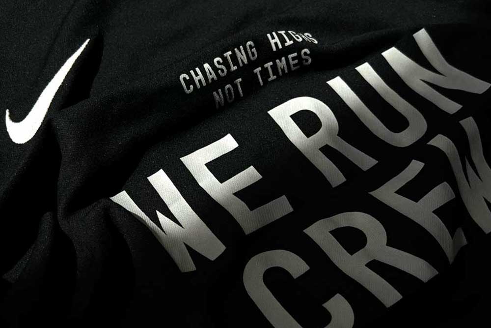 A close up shot of a Nike running tshirt, with the words We Run Crew